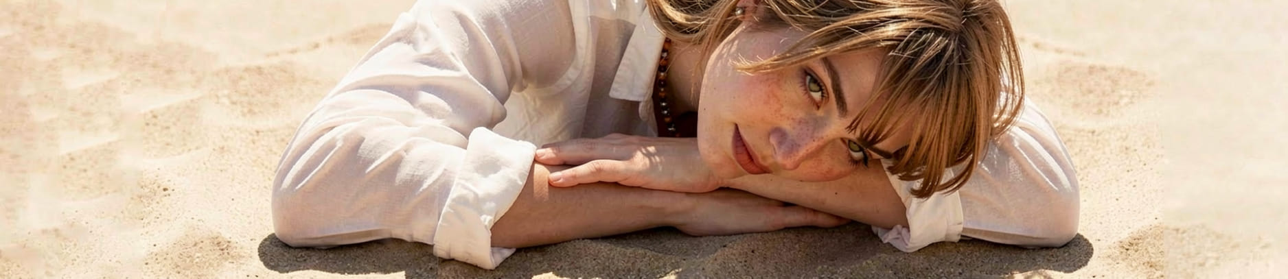 Modella con collana in ambra balticasu sfondo sabbioso - Bellavere gioielleria Karatis Abano Terme